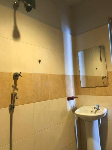 a bathroom with a sink and a mirror at Suhaila Palace in Perhentian Islands