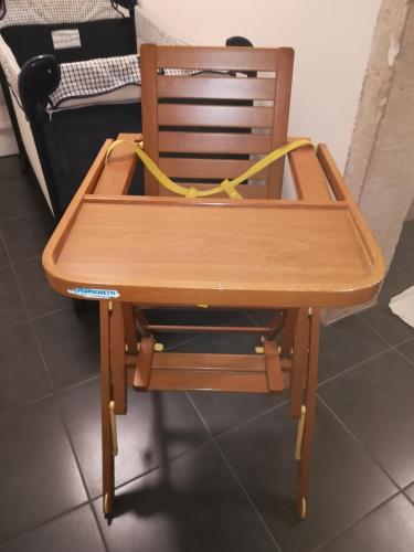 a wooden chair with a yellow ribbon on it at Casa Diso 2016 in Vittorio Veneto