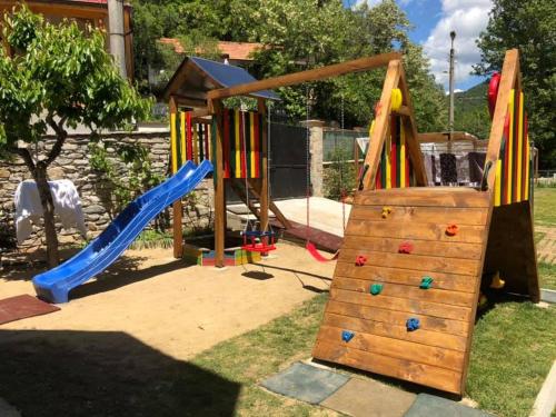 a playground with a slide and a climbing frame at Family Hotel BOHEMA in Ognyanovo