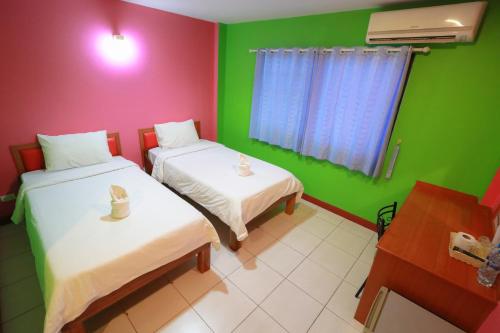 Un ou plusieurs lits dans un hébergement de l'établissement Chiang Rai Park Resort