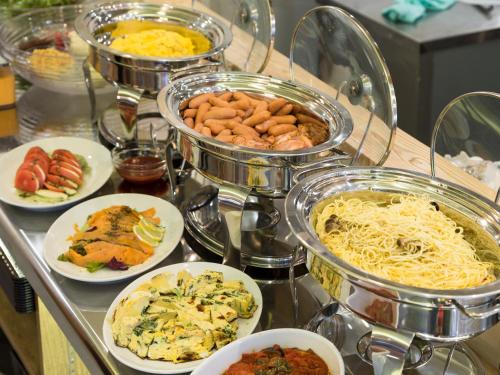 a buffet of different types of food on a table at APA Hotel Yamanote Otsuka Ekimae Tower in Tokyo