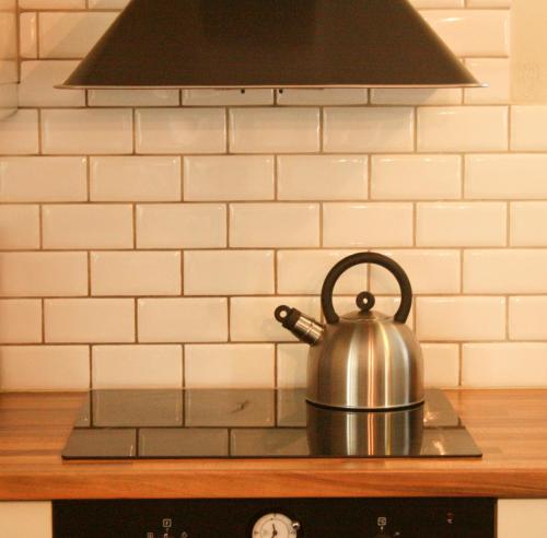 a tea kettle sitting on top of a stove at Grönelid Gård in Tived