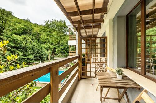 a balcony of a house with a view of a pool at Family Hotel BOHEMA in Ognyanovo