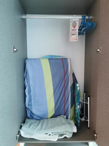 a suitcase is sitting on a shelf in a room at Harmony Studio @ Evo SOHO Bangi in Kampong Sungai Ramal Dalam