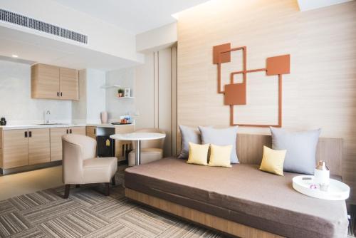 a hotel room with a bed and a kitchen at twothree a homely hotel - SHA Extra Plus in Bangkok
