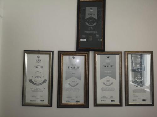 a group of four framed pictures on a wall at Rose and Ale Self Catering Units in Gonubie