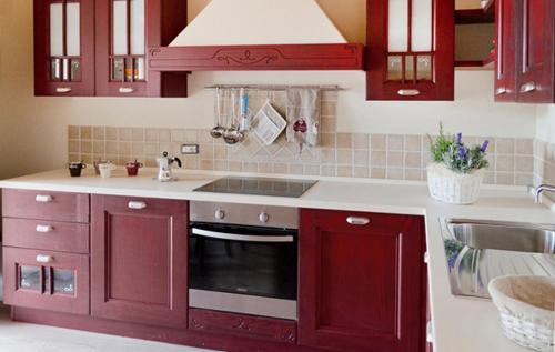 a kitchen with red cabinets and a sink at Agriturismo La Perla in Monte San Pietrangeli