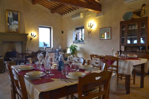 a dining room with a table with plates and wine glasses at Agriturismo Re Tarquinio in Tuscania