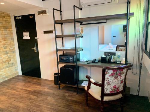 a room with a desk and a loft bed at JonkeRED Heritage Hotel in Malacca
