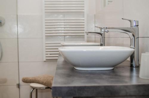 a bathroom with a white bowl sink on a counter at Apartments Blaickner in Neukirchen am Großvenediger