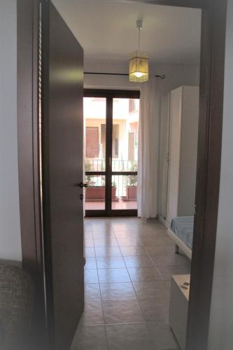 a door leading to a room with a balcony at Poseidone Sea Apartment Taormina in Mazzeo