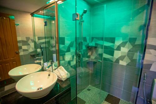 a bathroom with a sink and a glass shower at Prestige Residences at Golden Valley by Grand United Hospitality in Yangon