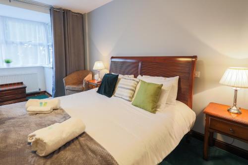 a bedroom with a large bed and a window at The Clee Hotel - Cleethorpes, Grimsby, Lincolnshire in Cleethorpes