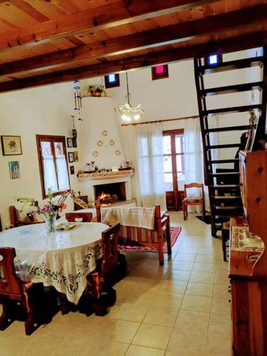 a living room with a table and a fireplace at Villa Annoula in Pouríon