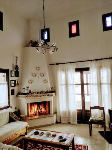 a living room with a couch and a fireplace at Villa Annoula in Pouríon