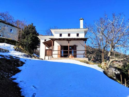 a small white house in the snow at Villa Annoula in Pouríon