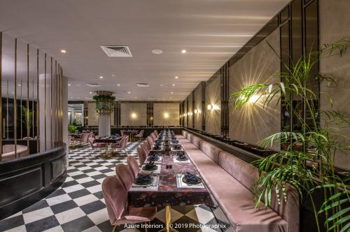 a restaurant with couches and tables in a lobby at Clarks Inn Suites Raipur in Raipur