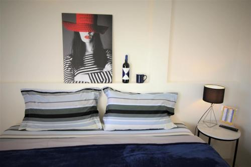 a bedroom with a bed with a picture of a woman at Sun & Sea Nai Yang Phuket in Nai Yang Beach