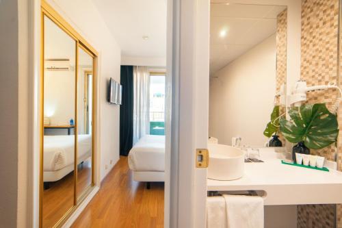 a bathroom with a sink and a mirror at Hotel Cetina Murcia in Murcia