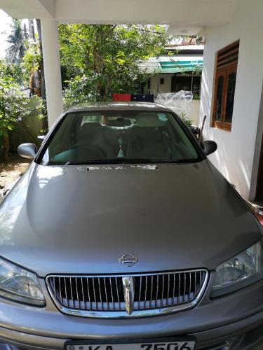 a silver car parked in front of a house at Villa Ok in Unawatuna
