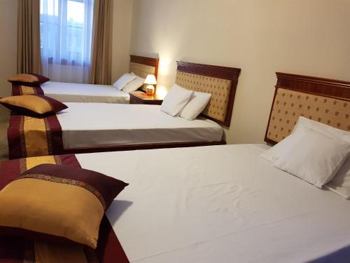 a hotel room with two beds and a window at Rezydencja Pod Zegarem in Trzebinia