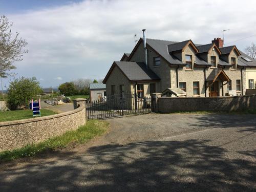 a large house with a fence in front of it at Portrush/ballyhome in Portrush