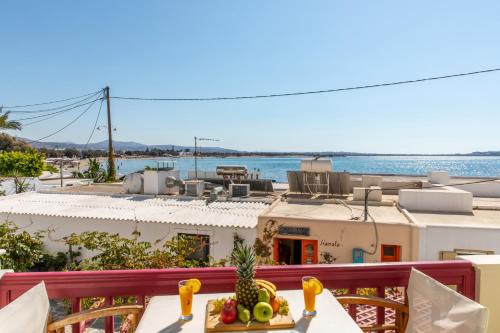 a table with fruit on top of a balcony at Hotel Palatia in Naxos Chora