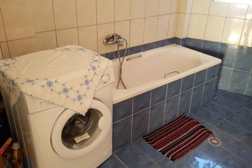 a bathroom with a toilet and a bath tub with a sink at Koulas House in Diava in Kalabaka