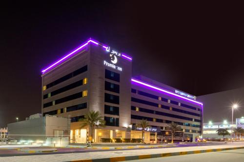 
a large building with a clock on the side of it at Premier Inn Abu Dhabi International Airport in Abu Dhabi
