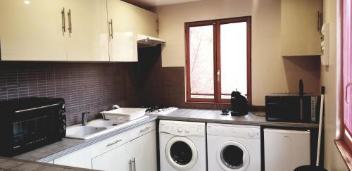 a kitchen with two washers and a sink at Gîte Coeur de Lorraine in Manoncourt sur Seille-Belleau