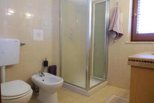 a bathroom with a shower and a toilet and a sink at Poseidone Sea Apartment Taormina in Mazzeo
