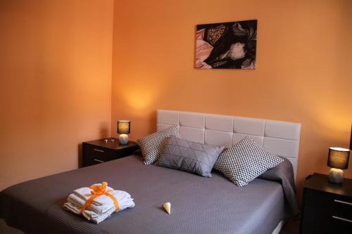 a bedroom with a bed with towels on it at Poseidone Sea Apartment Taormina in Mazzeo