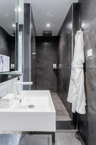 a bathroom with a white sink and a mirror at The Inn on the Mile in Edinburgh