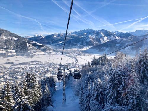 a ski lift going up a snow covered mountain at Casa Montana in Niedernsill