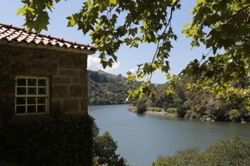 a building with a view of a river at Casa da Figueira Velha in Resende