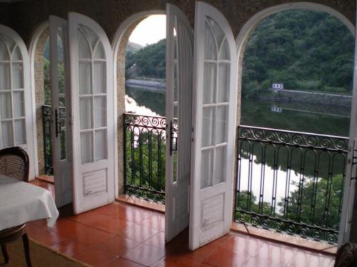 an open door to a balcony with a view at Casa da Figueira Velha in Resende