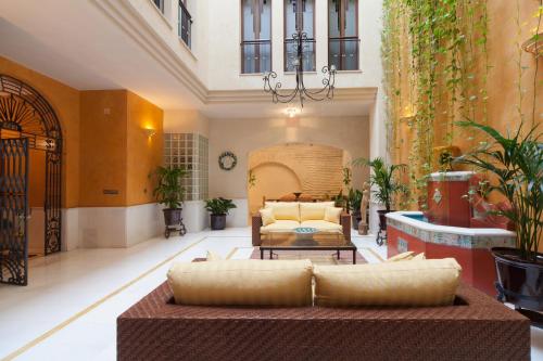 a living room with a couch and a table at Logia Sevilla in Seville