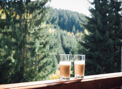 two glasses of milk sitting on a window sill at Casa Cifu Toplita in Topliţa