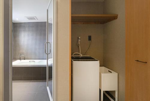 a bathroom with a shower and a sink at MATERIAL Fuchomae in Kyoto