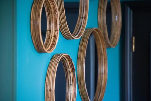 a wooden number hanging on a blue wall at County Arms in Truro
