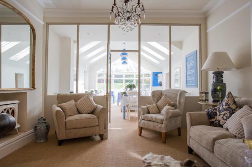 a living room with chairs and a chandelier at Grays Boutique B&B in Bath