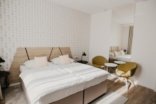Un pat sau paturi într-o cameră la Hotel Patria