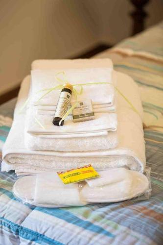 a stack of towels on a bed with a bottle of mascara at B&B PALAZZI in Florence