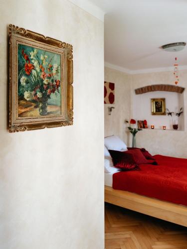 a bedroom with a painting of a vase of flowers at Boutique Hotel Romantick in Český Krumlov