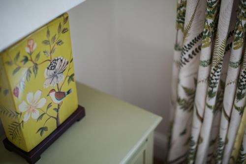 a room with a table and a curtain with flowers at Grays Boutique B&B in Bath
