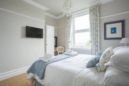 a bedroom with a white bed and a window at Grays Boutique B&B in Bath