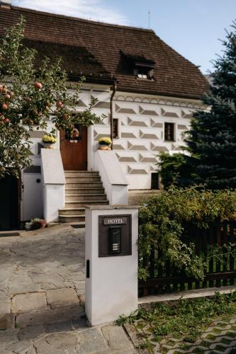 a small refrigerator in front of a white house at Boutique Hotel Romantick in Český Krumlov