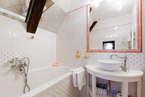a bathroom with a sink, toilet and bathtub at Boutique Hotel Romantick in Český Krumlov