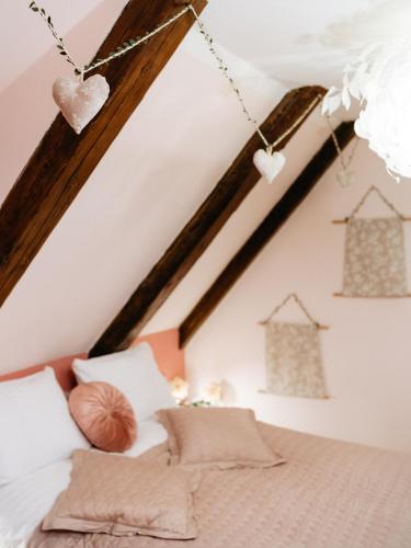 a bedroom with a bed with hearts hanging from the ceiling at Boutique Hotel Romantick in Český Krumlov
