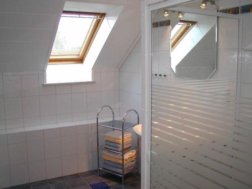 a bathroom with a shower and a stack of towels at Ferienhaus Günztal, Fam. Botzenhart in Ellzee